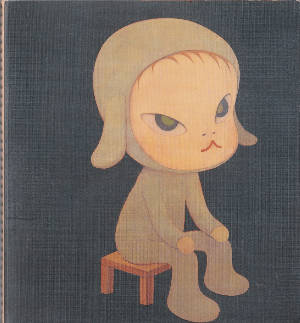 Scan of a notebook cover. On it is a cartoon child wearing a bunny outfit, sitting on a stool.